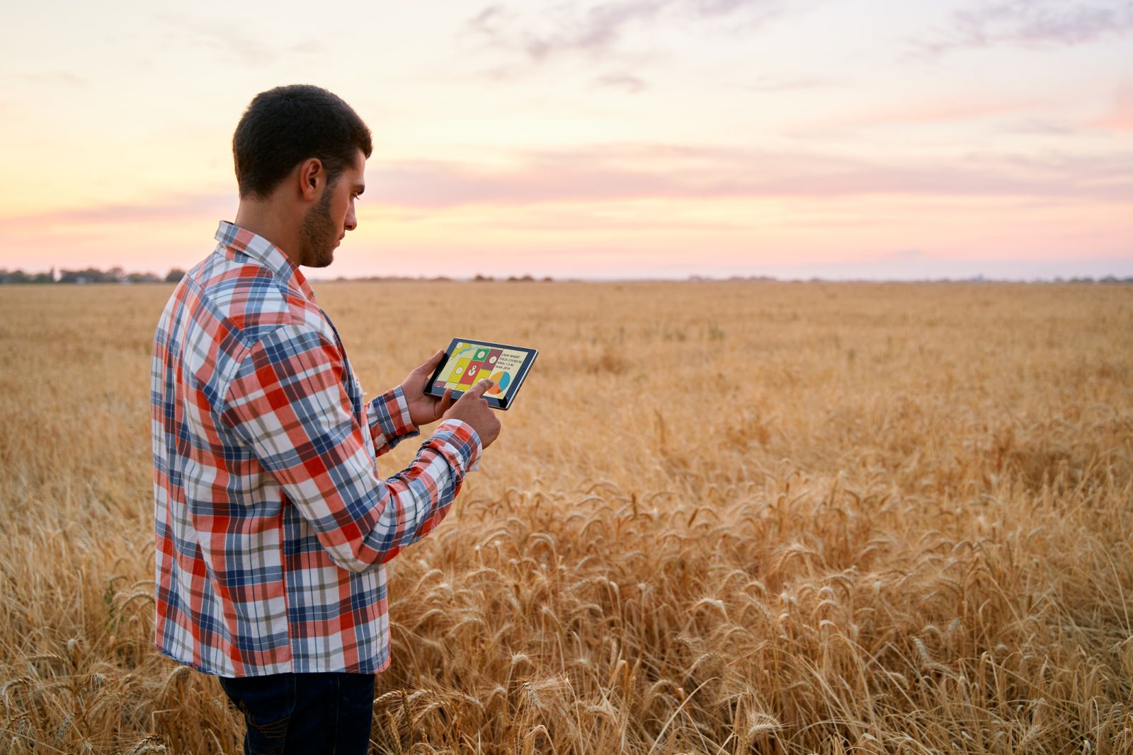 Farmer holds tablet using online data management by artiemedvedev via iStock